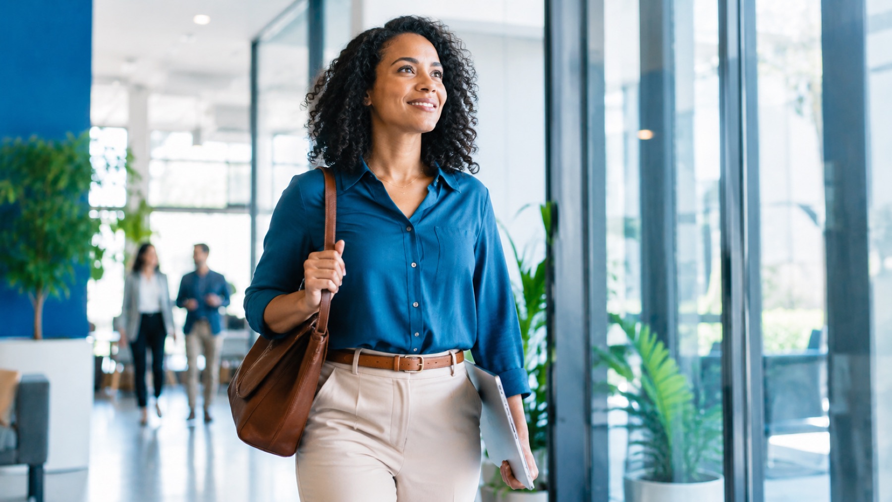 Confident professional walking through a modern workplace lobby