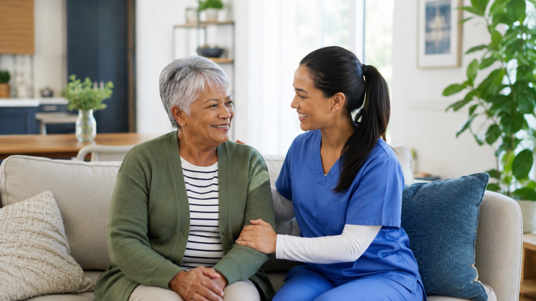 Caregiver and older adult talking together in a comfortable home setting